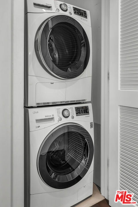 laundry room featuring stacked washing maching and dryer