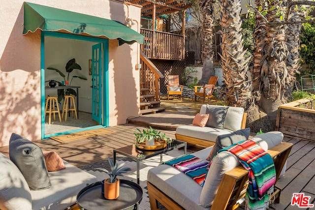 view of patio with an outdoor living space and a deck