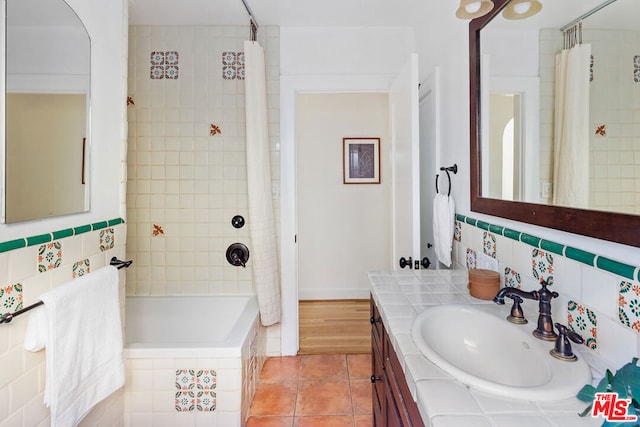 bathroom featuring vanity, tile patterned flooring, decorative backsplash, and shower / bath combo