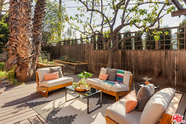 wooden deck with an outdoor living space