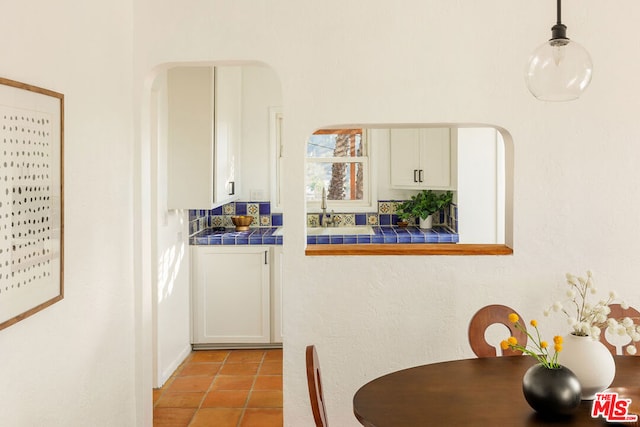 dining space featuring light tile patterned floors and sink