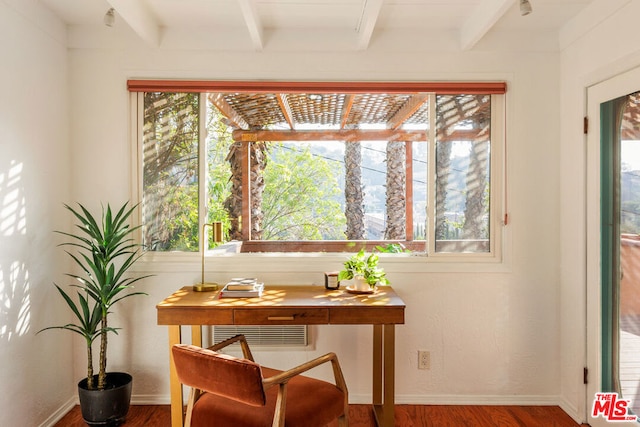 office space featuring wood-type flooring, beam ceiling, and plenty of natural light