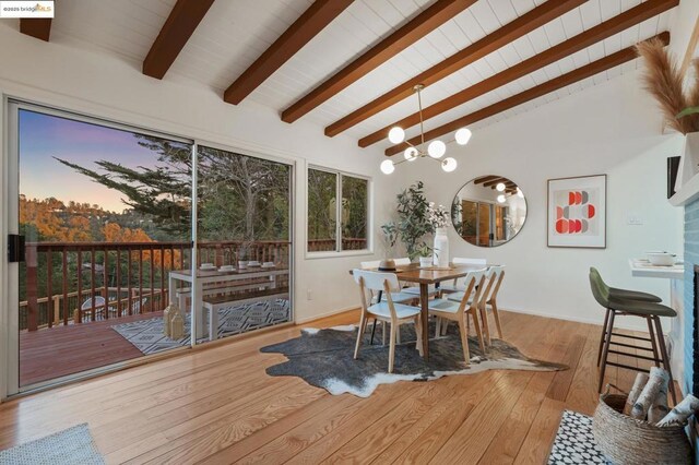 interior space featuring beam ceiling, light wood-type flooring, and high vaulted ceiling