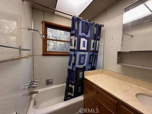 full bath featuring shower / bath combo and vanity