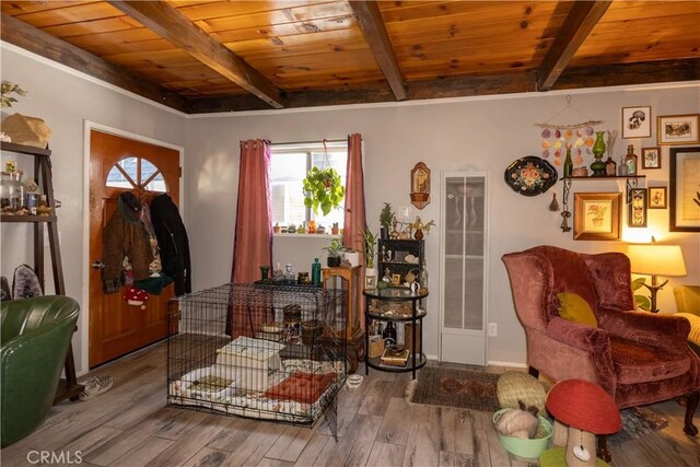 sitting room with wooden ceiling, beamed ceiling, and light hardwood / wood-style floors