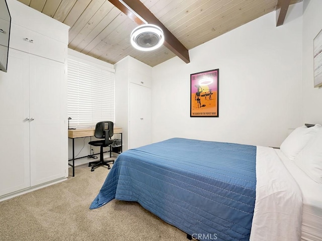 bedroom with beam ceiling, light colored carpet, and wood ceiling