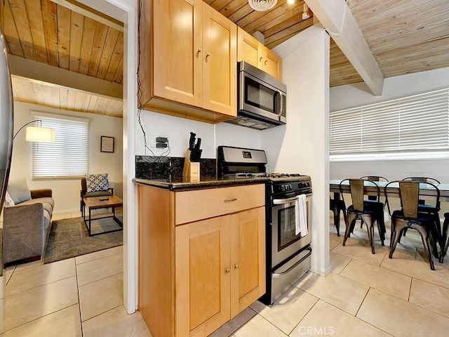 kitchen with appliances with stainless steel finishes, wood ceiling, light brown cabinets, and beamed ceiling