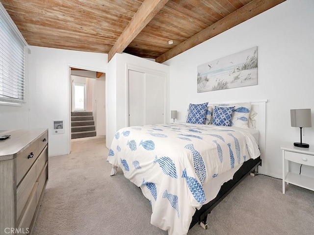 carpeted bedroom featuring vaulted ceiling with beams and wooden ceiling