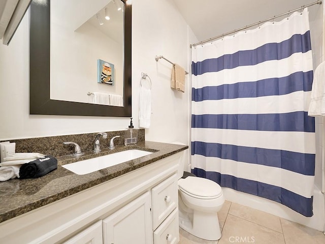 bathroom with toilet, tile patterned flooring, a shower with curtain, and vanity