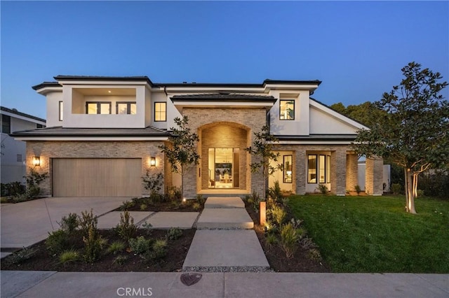 view of front of house with a garage and a lawn