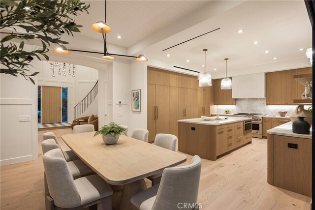 dining room featuring a barn door and light hardwood / wood-style floors