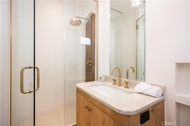 bathroom with walk in shower and vanity