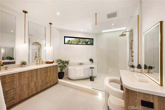 bathroom with vanity and separate shower and tub