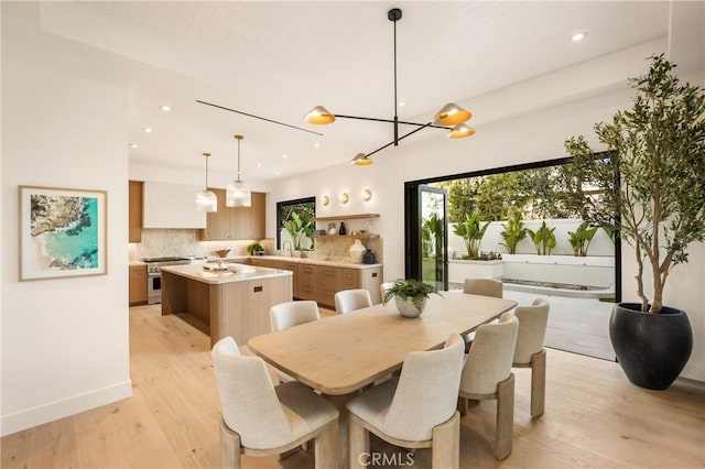 dining space featuring sink and light hardwood / wood-style flooring