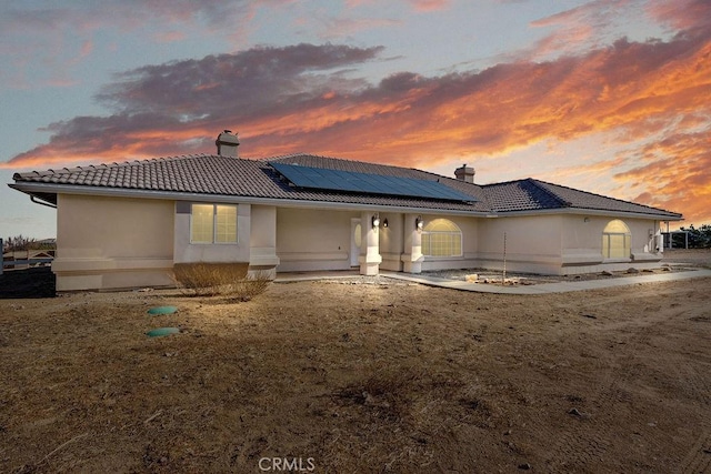 back house at dusk with solar panels