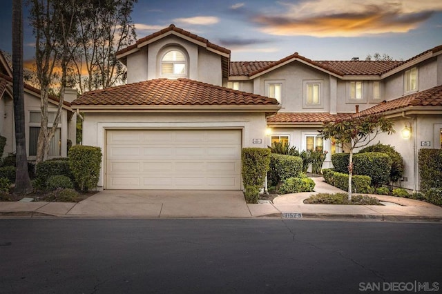 mediterranean / spanish home with a garage