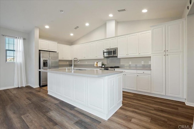 kitchen with a kitchen island with sink, appliances with stainless steel finishes, sink, and white cabinetry