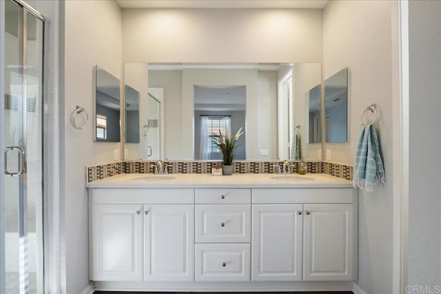 bathroom featuring walk in shower, tasteful backsplash, and vanity