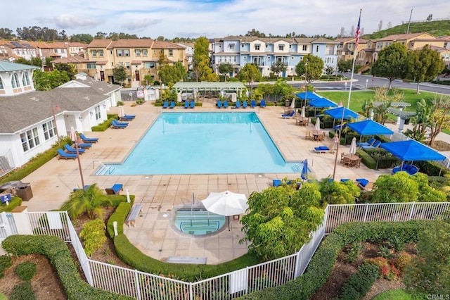 view of swimming pool featuring an outdoor hot tub and a patio