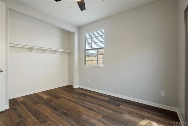 unfurnished bedroom featuring dark wood-type flooring, ceiling fan, and a closet