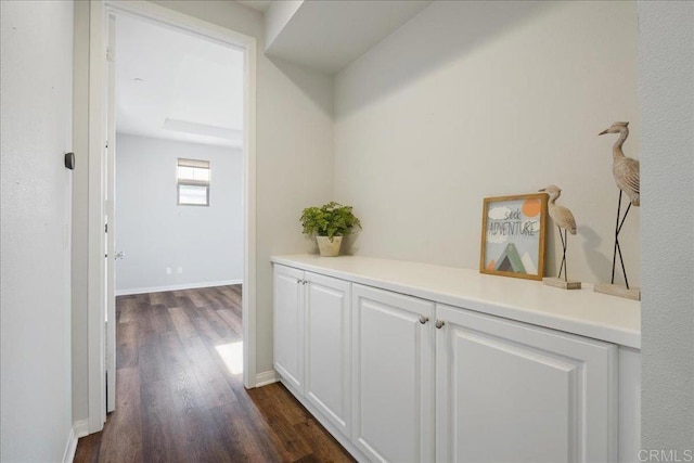 hallway with dark hardwood / wood-style floors