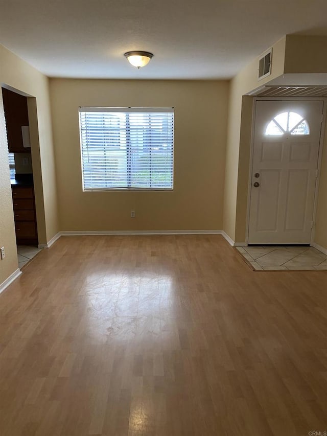 foyer entrance with light hardwood / wood-style floors