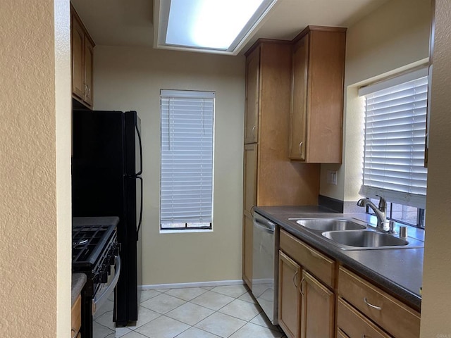 kitchen featuring light tile patterned floors, stainless steel dishwasher, gas stove, and sink