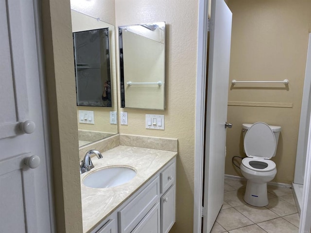 bathroom featuring toilet, vanity, and tile patterned floors