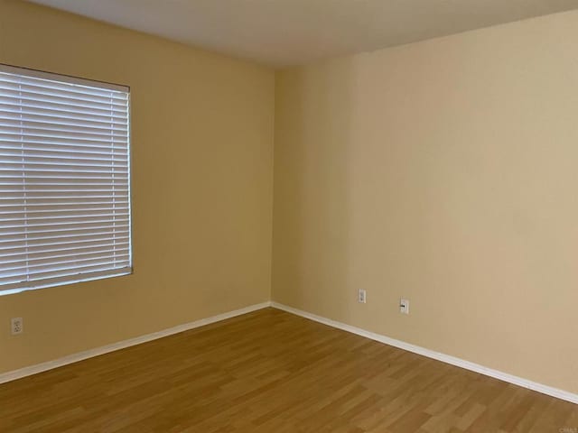 empty room with hardwood / wood-style floors