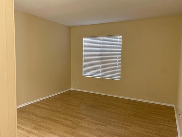 spare room with light wood-type flooring