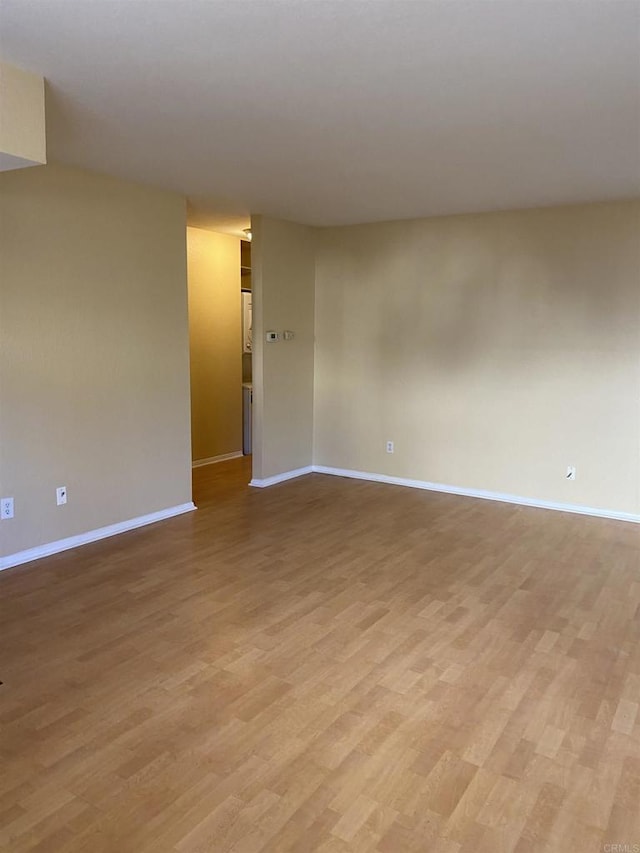 unfurnished room with light hardwood / wood-style floors