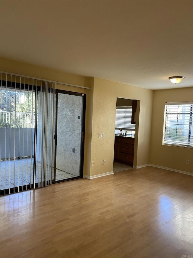 empty room with light hardwood / wood-style flooring