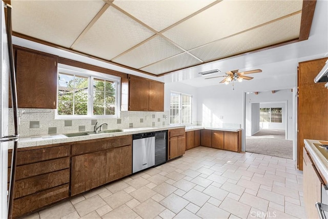 kitchen with decorative backsplash, sink, stainless steel appliances, and a healthy amount of sunlight