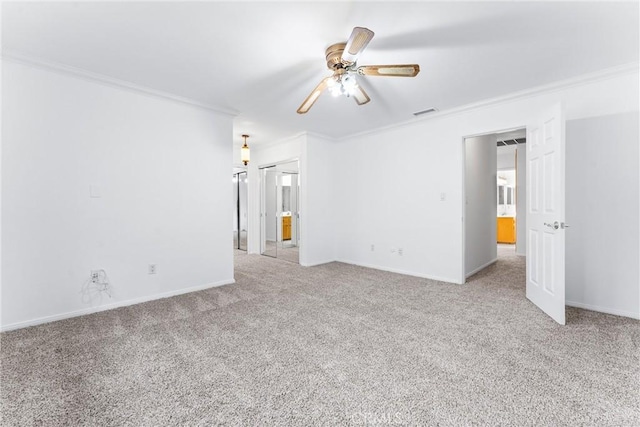 spare room featuring light carpet, ceiling fan, and ornamental molding