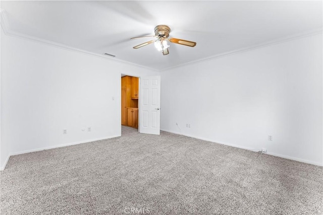 carpeted empty room featuring ceiling fan and crown molding