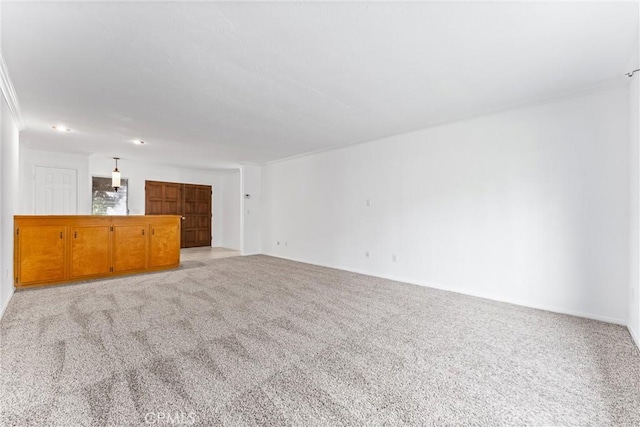 unfurnished living room featuring light carpet and crown molding