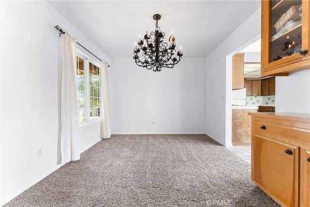 unfurnished dining area featuring light carpet and a chandelier