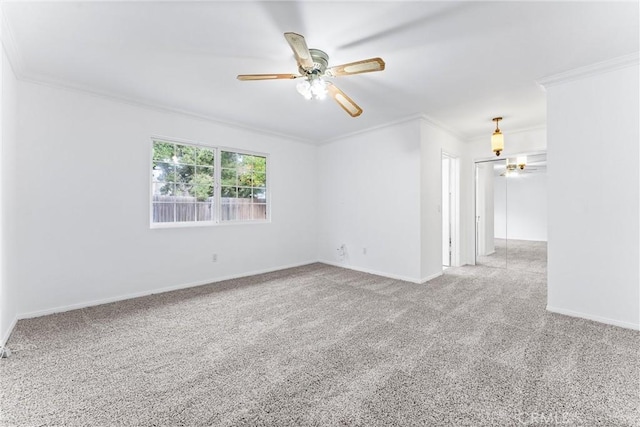 carpeted empty room featuring ceiling fan and ornamental molding