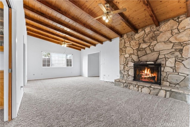 unfurnished living room featuring wood ceiling, vaulted ceiling with beams, a fireplace, carpet flooring, and ceiling fan