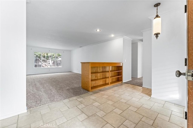 empty room featuring light carpet and crown molding