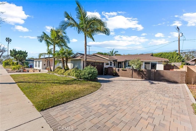 ranch-style house with a garage and a front yard