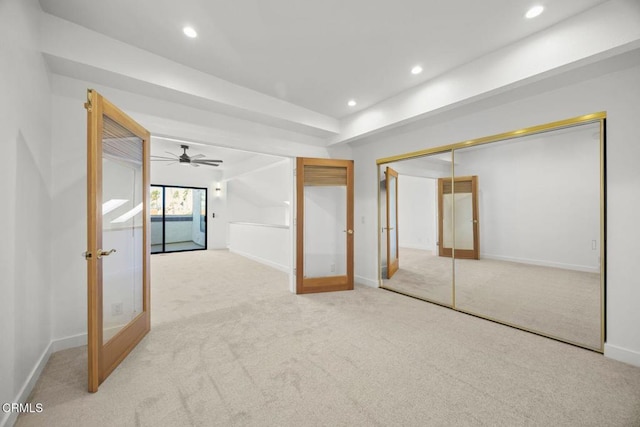 interior space featuring recessed lighting, french doors, and light carpet