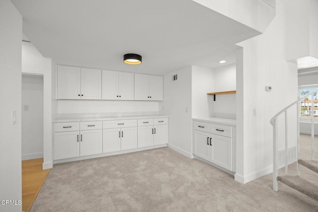 kitchen with white cabinetry, baseboards, and open shelves