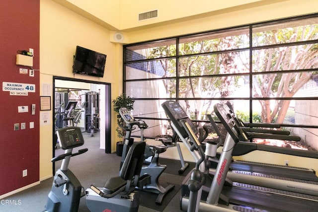 gym with visible vents, plenty of natural light, and baseboards