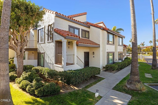 view of front of home with stucco siding and a tiled roof