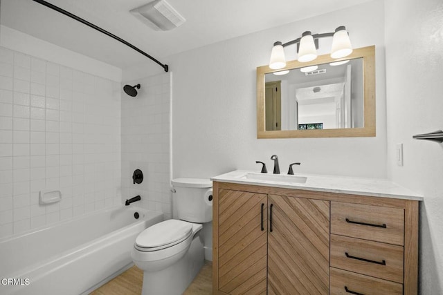 bathroom with bathing tub / shower combination, visible vents, toilet, and vanity