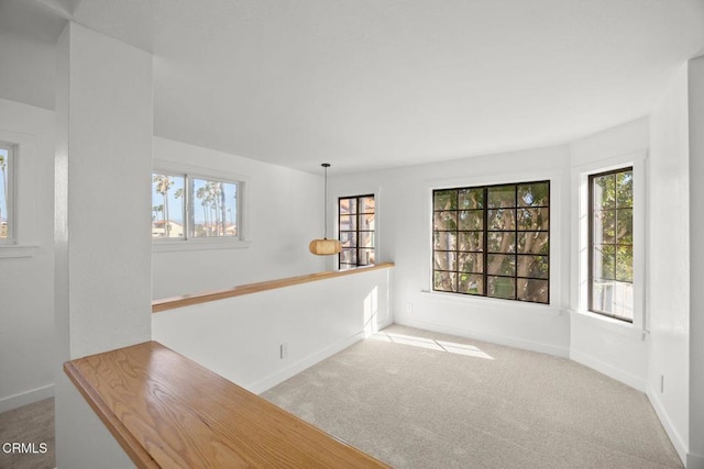 empty room featuring baseboards and carpet floors