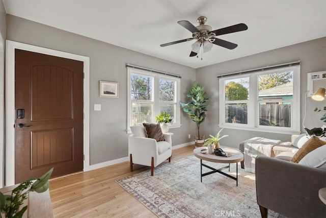 living room with ceiling fan and light hardwood / wood-style floors