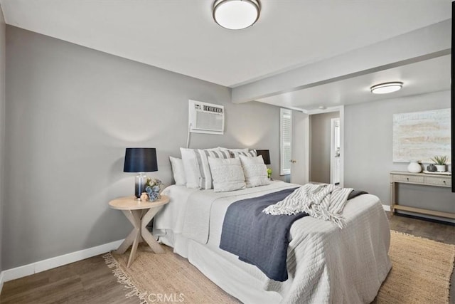 bedroom with hardwood / wood-style flooring and a wall mounted AC