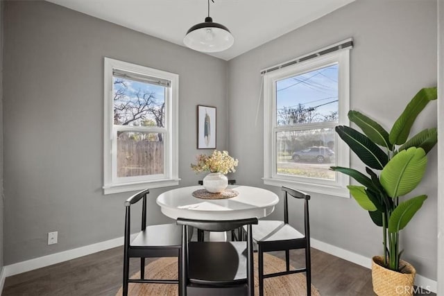 dining space featuring dark wood-type flooring and a wealth of natural light